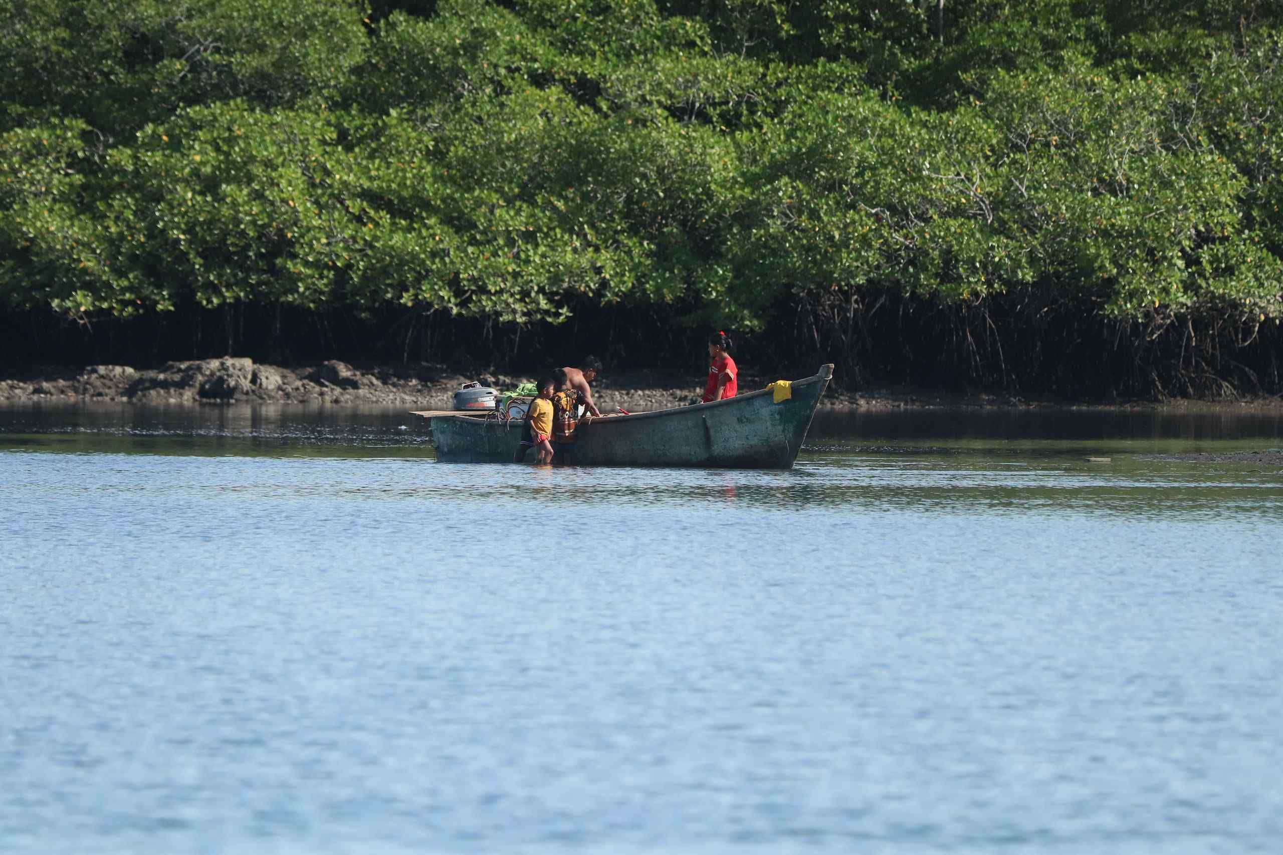 A family of fishermen are getting ready for the day in the waters of Gulf of Chiriqui.